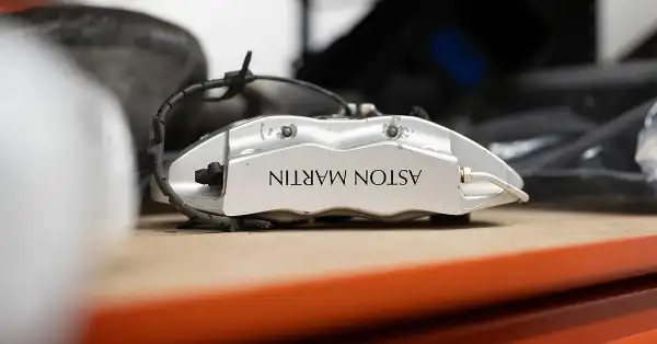 Genuine Aston Martin silver brake calliper on a shelf in the Eurospares warehouse.