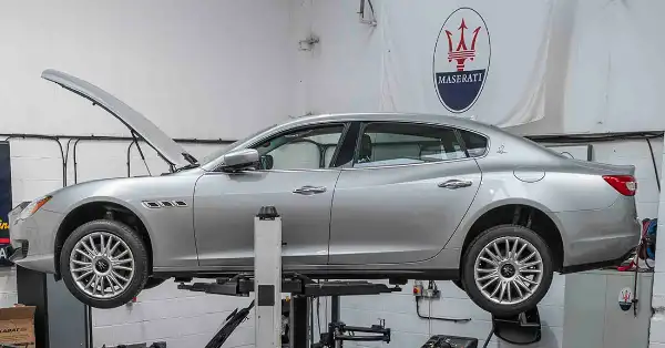 A Maserati Quattroporte up on the car lift in the Eurospares dismantling workshop.