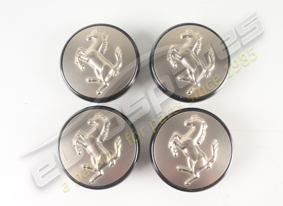 NEW FERRARI SET 4 TITANIUM PUSH IN HUB CAPS. PART NUMBER 70001285 (1) new ferrari set 4 titanium push in hub caps. part number 70001285 (1)